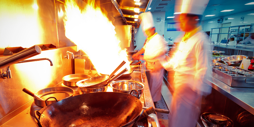 Professional cooks in the kitchen with kitchen utensils