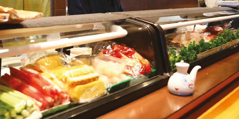 Sushi display with fresh goods in the salesroom.